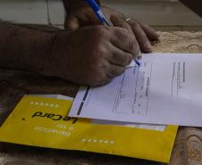 Equipes do Estado percorrem Rio Bonito do Iguaçu para entregar Cartões Reconstrução às famílias